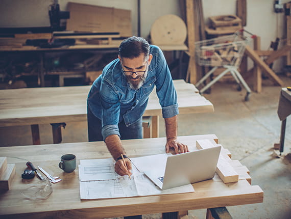 Mature Caucasian man working on plans