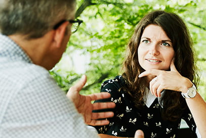 Caucasian woman intently listening to Caucasian man