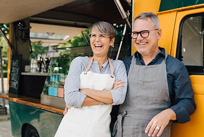 Mature Caucasian couple working together at a food truck