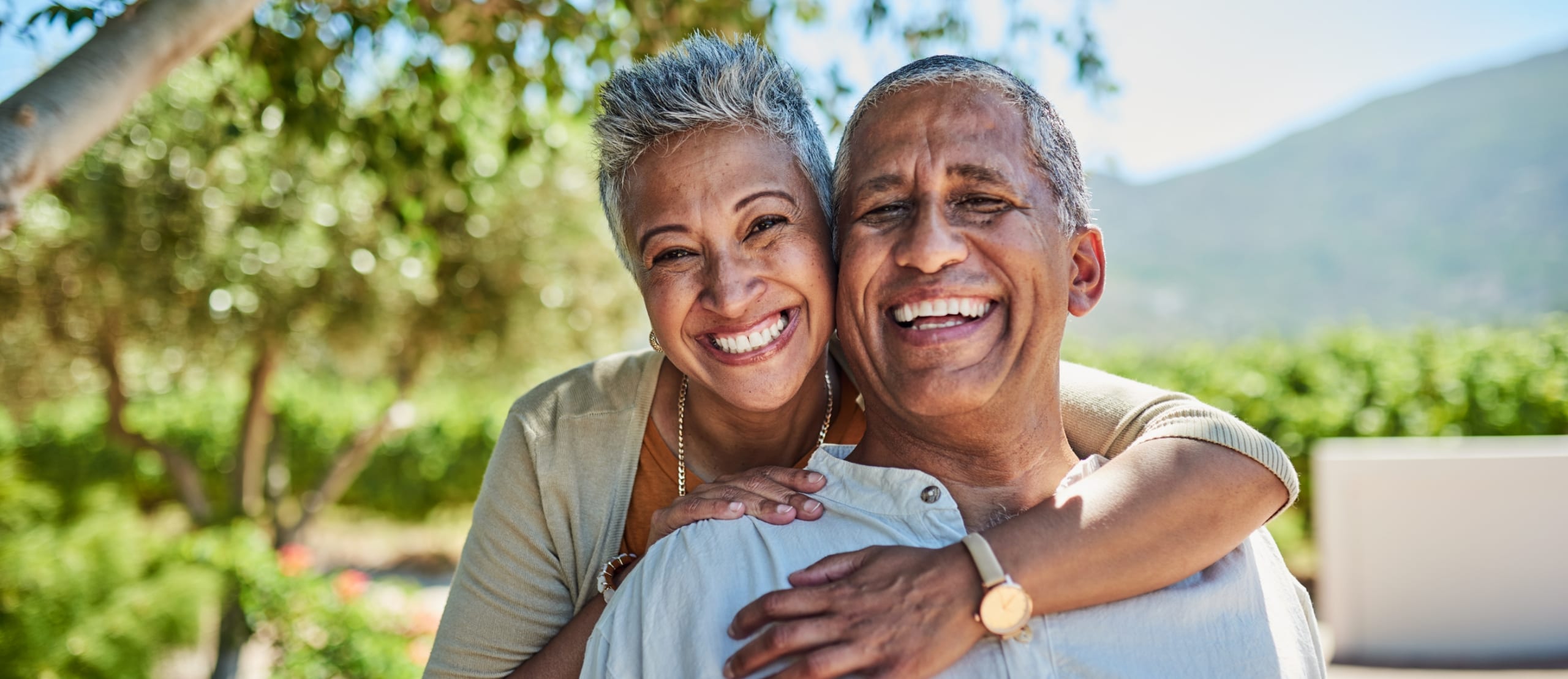 Portrait of elderly man and woman together for fresh air and tree view on vacation