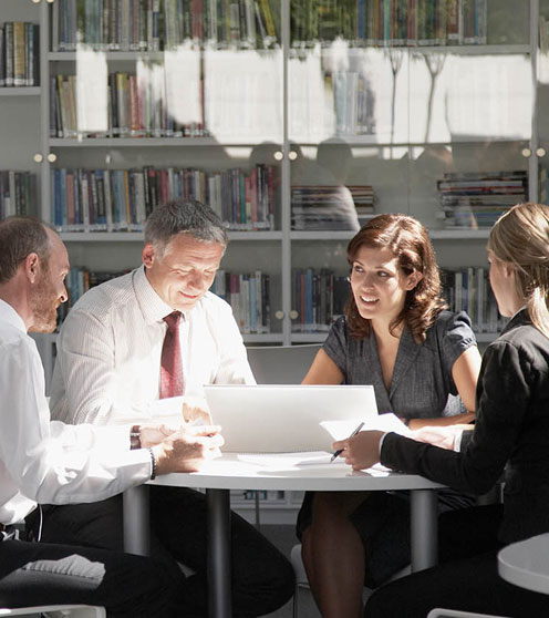 Business people working in library.