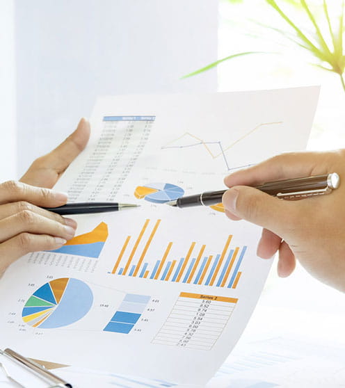 Business people working with charts on paper.