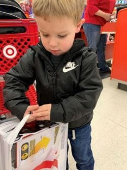 Young Boy Carrying Toys