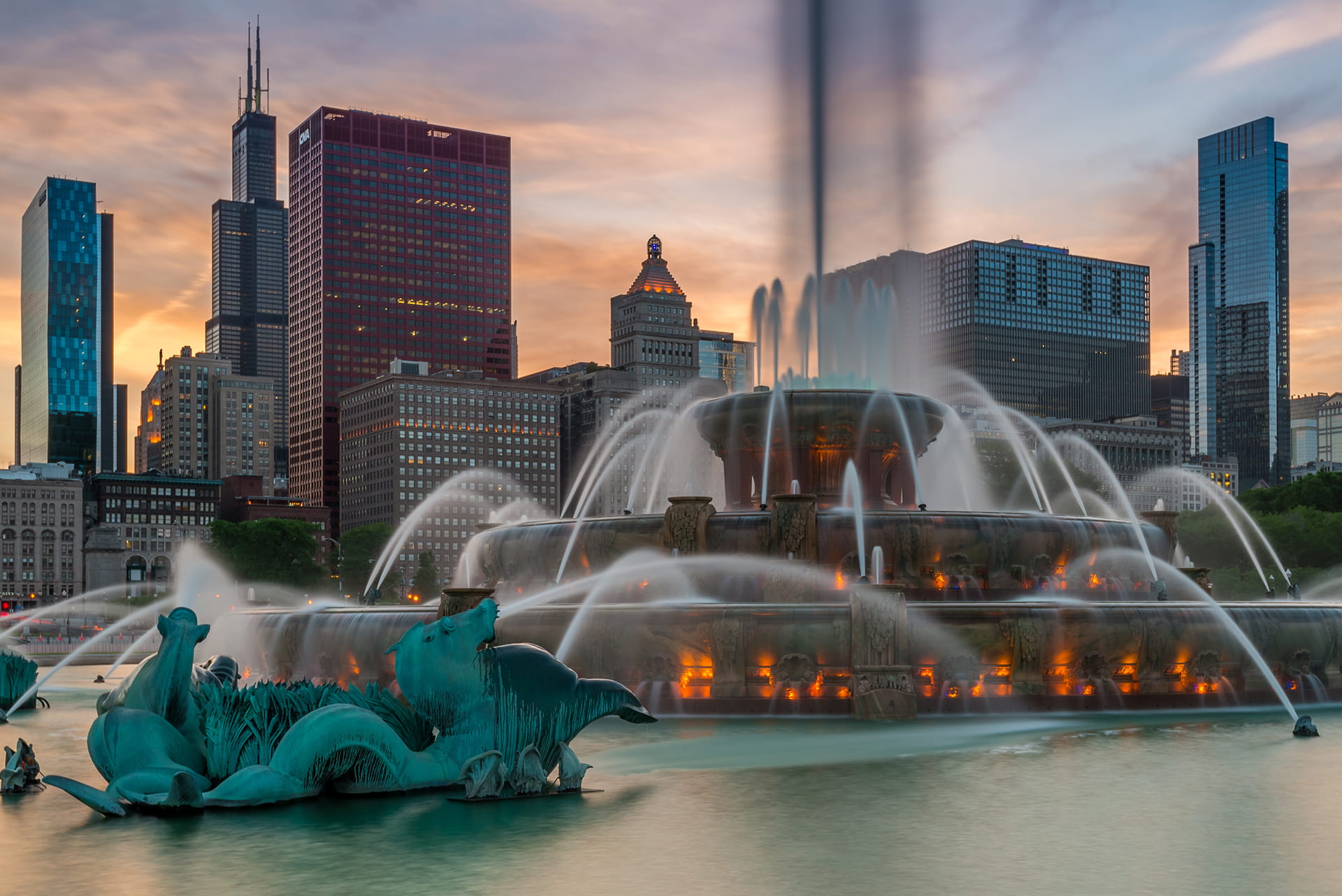 Chicago, Buckingham Fountain and skyscrapers against evening sky