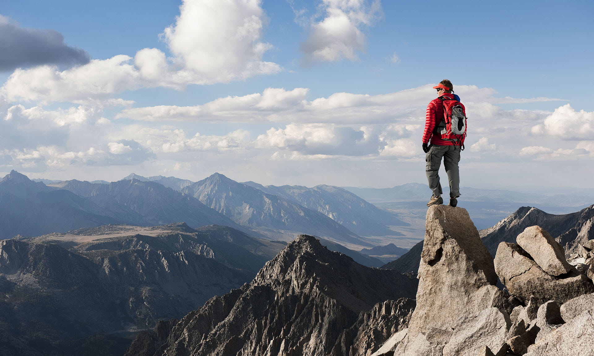 A person standing atop a mountain