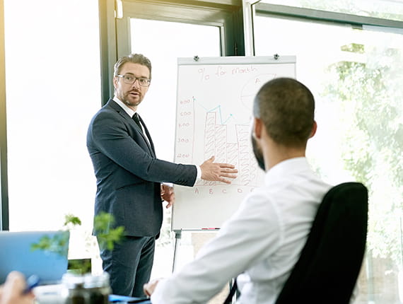 Businessman explaining chart in presentation