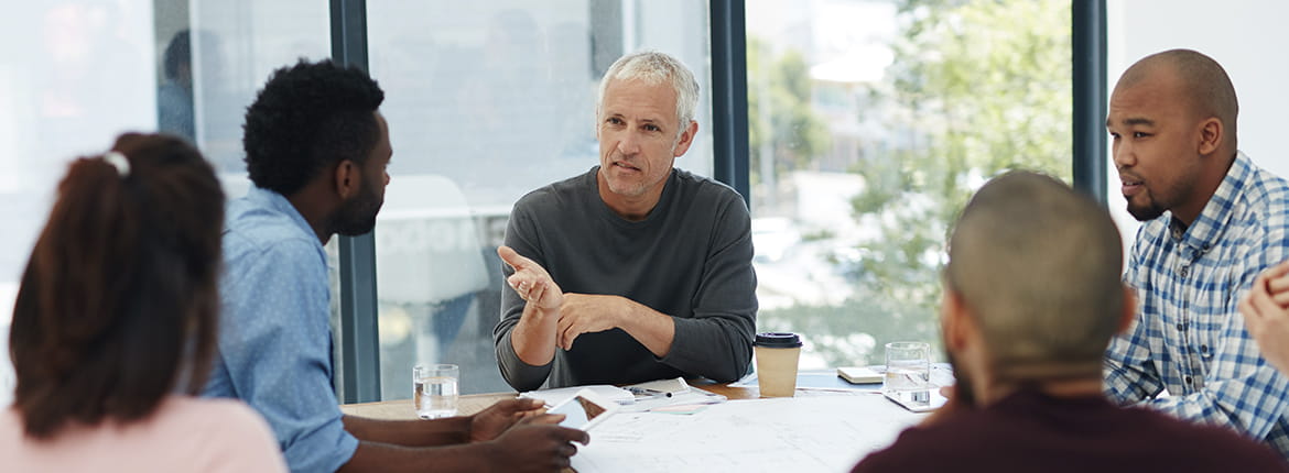 People sitting around a table having a conversation. 