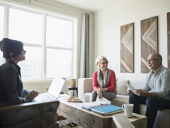 Mature Caucasian couple talking to female advisor
