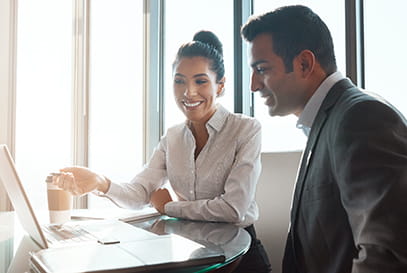 Indian businessman businesswoman talking with laptop. 