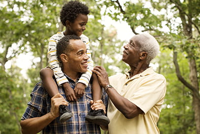 Black father son grandfather in park