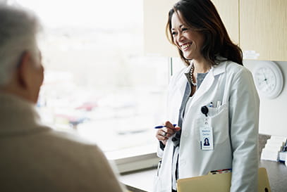 Young female doctor smiling at a patient