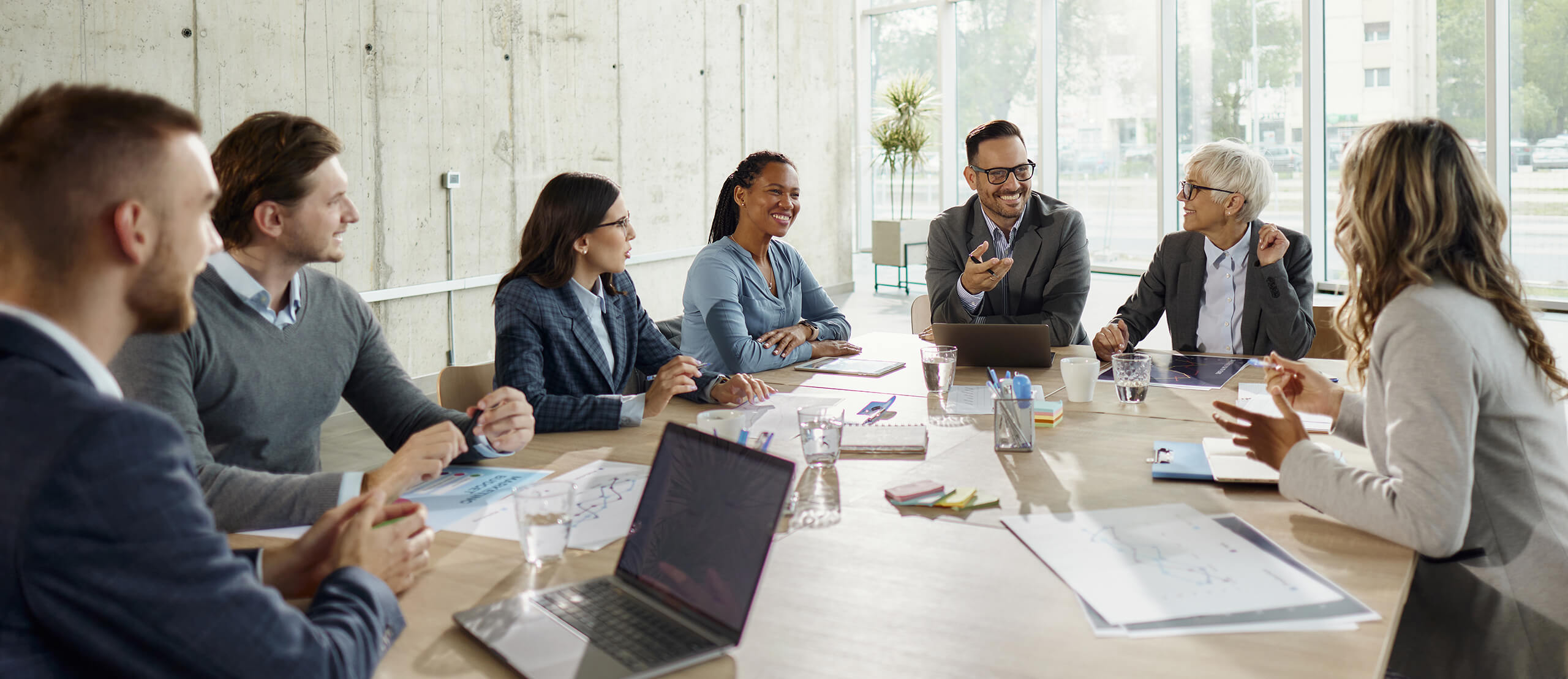 Large group of happy business colleagues communicating while working on a meeting in the office