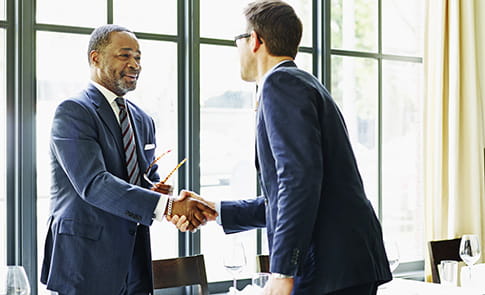 Financial advisor shaking hands with client