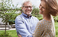 Happy mature couple dancing in garden