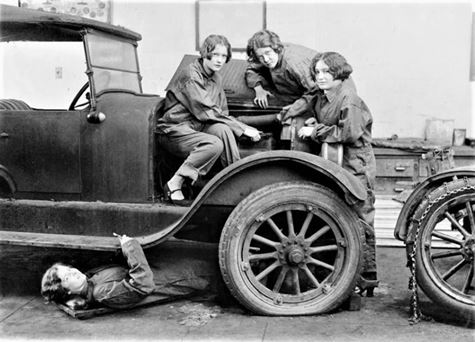 old photo of four high school girls on a car.