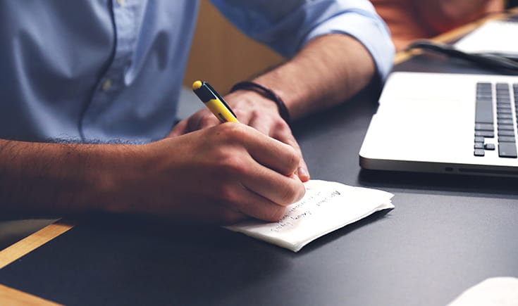 Writing on paper at a desk