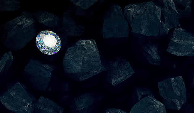 Diamond laying among coals