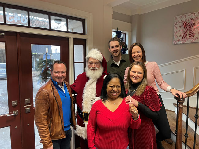 FLWP team with santa at the office