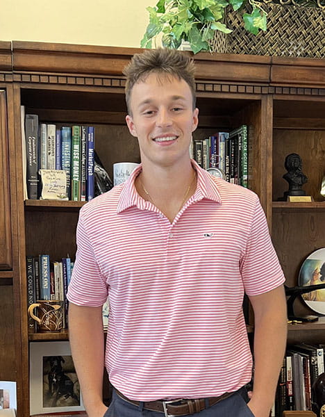 Evan Jacklin standing in front of a bookcase