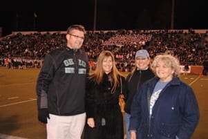 Goldsberry Wealth Strategies team on the field to present a check to the Ohio Bobcats Football Friends of the Shelter organization.