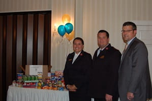 Goldsberry Wealth Strategies team in front of donated food items.