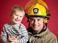 Firefighter holding child