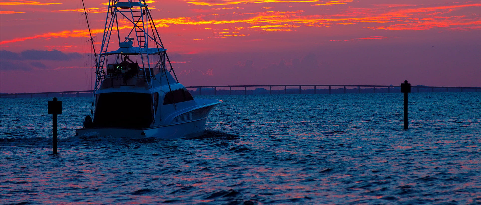 Homepage banner image - boat on the water at sunset