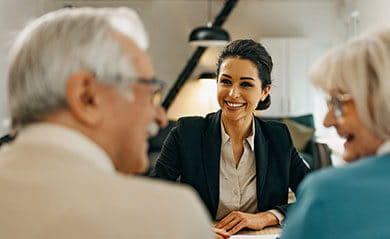 Senior couple consults with female real estate agent