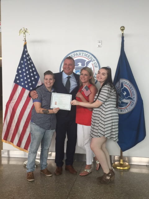 Mick holding certificate surrounded by family
