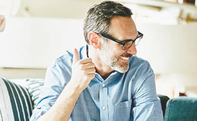 Laughing businessman in informal meeting in office with colleagues