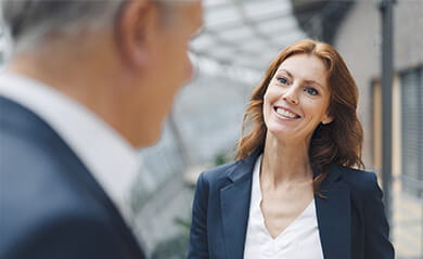 Portrait of smiling businesswoman talking to businessman