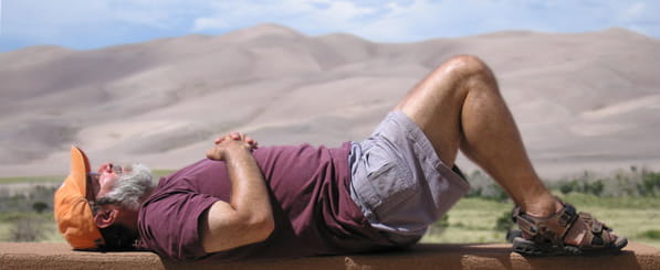 Meet Frank and Barbara - man resting on his back in front of mountain scape