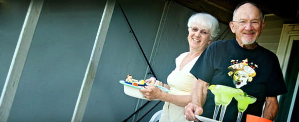Meet John and Ruth - smiling senior couple serving food and drinks