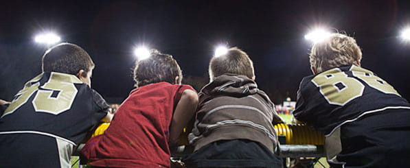 Meet Keith and Joanna - 4 boys watching a sporting event