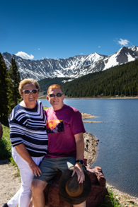 couple at the lake with a snowy mountain background