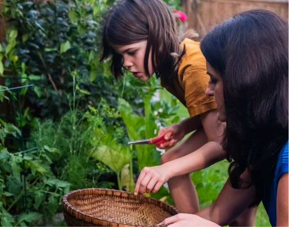 A brunette child working in the garden