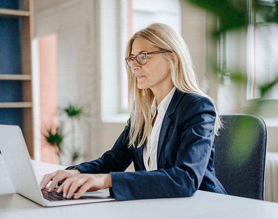Businesswoman using laptop in office