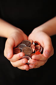 Child's hand holding coins