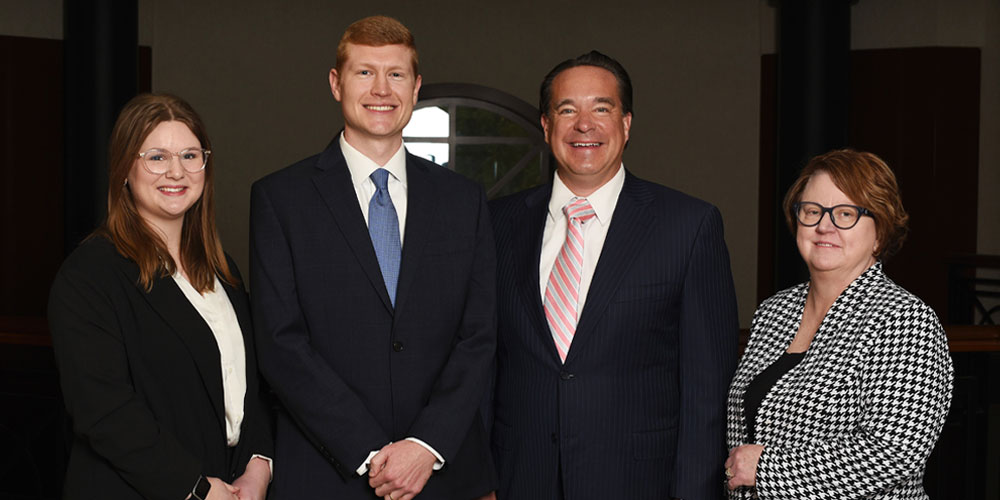 Group photo of team at Walz Advisory Group. Listed left to right: Livia Sullivan, Joseph Hamilton, Todd Walz, and Connie Vicars.