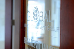 Global Wealth Management Group of Raymond James logo on a glass door.