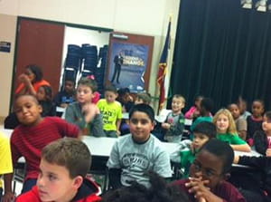Children at Daulton Elementary listen to Zach Scott.