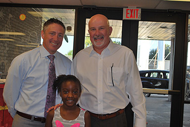 Zach and Scott pose with first place winner Gabriella at the breakfast party she won for her branch.