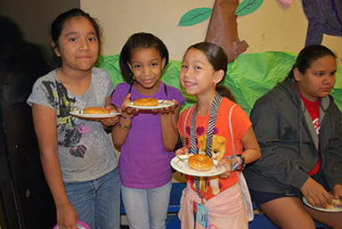 Girls having fun and enjoying their donuts!