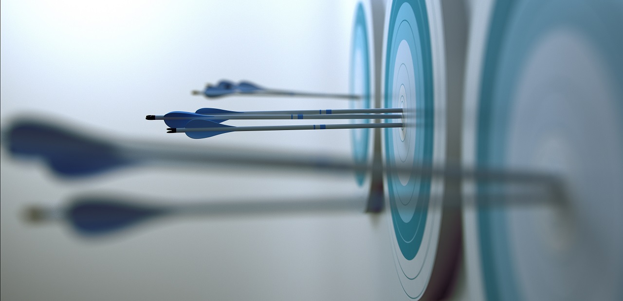 Row of archery targets from right to left with arrows piercing through the bullseye mark