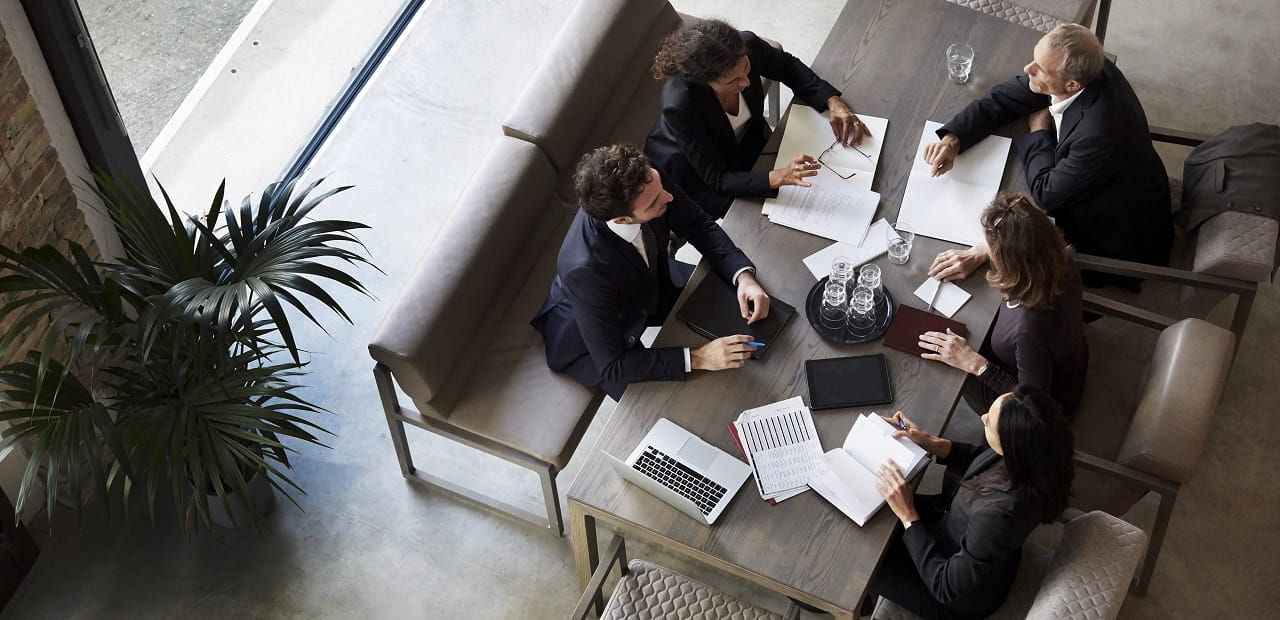 A high-angle view of a group of business professionals sitting together around a table