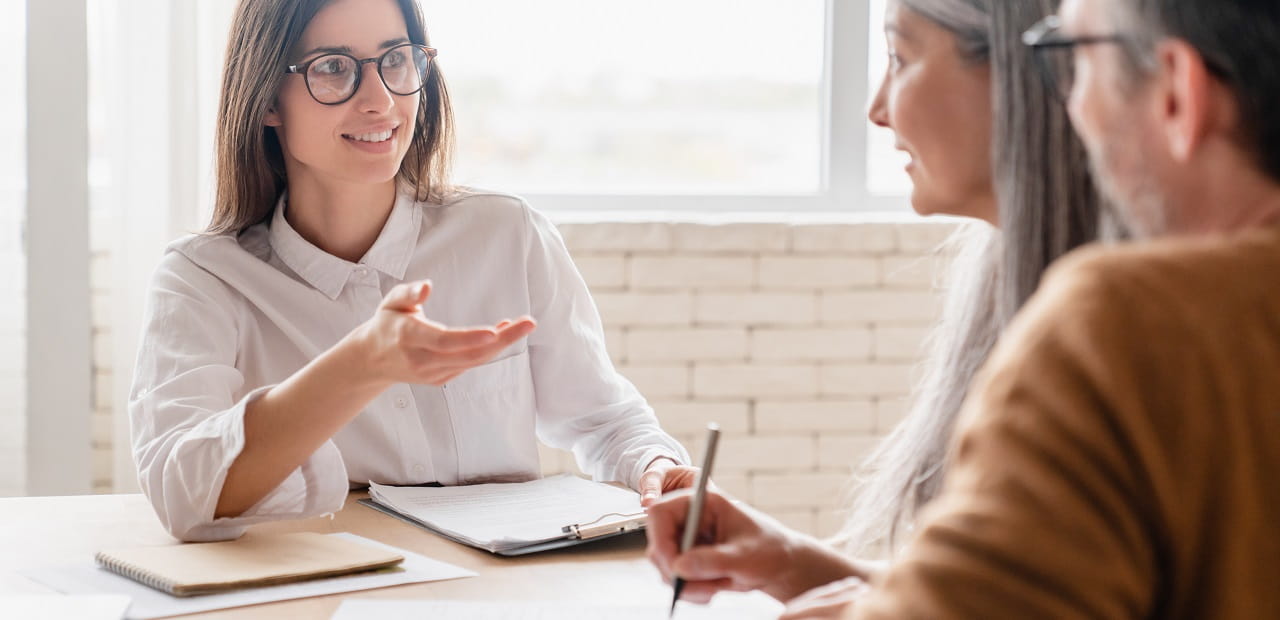 Mature couple speaking with their financial advisor.