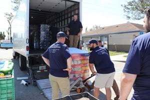 Associates unload a pallet of donated supplies