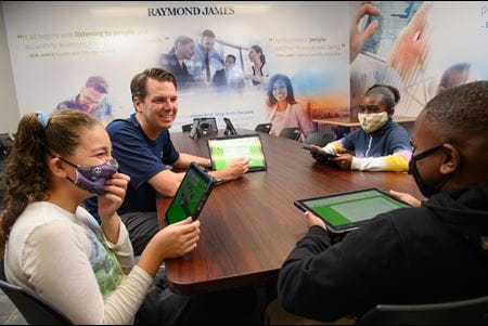 Raymond James leader Patrick O'Connor volunteers at Finance Park