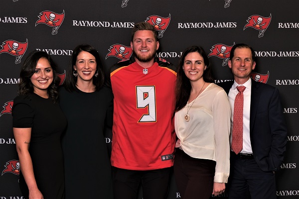 Raymond James associates pose with Buccaneers kicker Matt Gay
