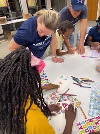 Raymond James volunteers make cards with kids at Mercy House